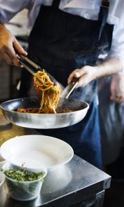 Chef cooking spaghetti in the kitchen